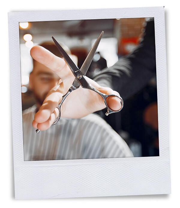 polaroid hand holding scissors